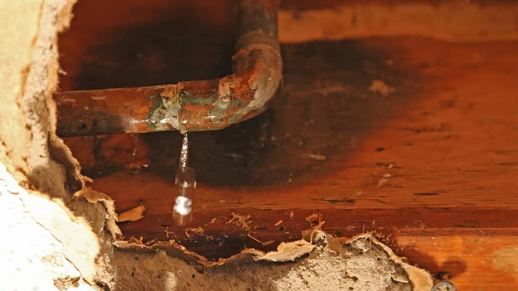 water leaking out of a copper pipe