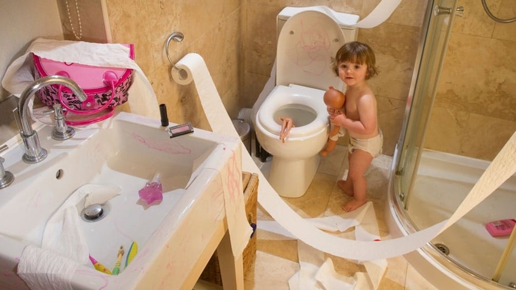 child flushing toys down toilet