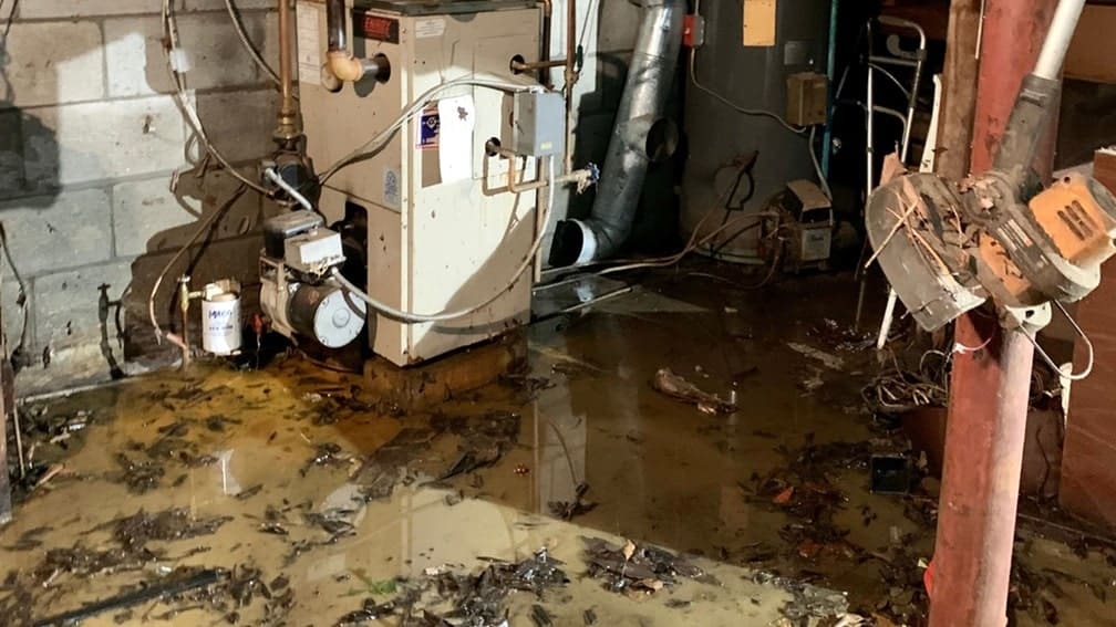 Flooded basement with debris and equipment